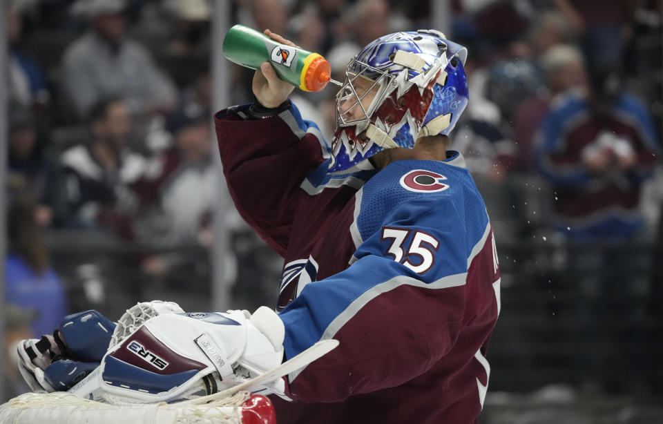 Colorado Avalanche goaltender Darcy Kuemper sprays water onto his face during the second period of Game 5 of the team's NHL hockey Stanley Cup second-round playoff series against the St. Louis Blues on Wednesday, May 25, 2022, in Denver. (AP Photo/David Zalubowski)