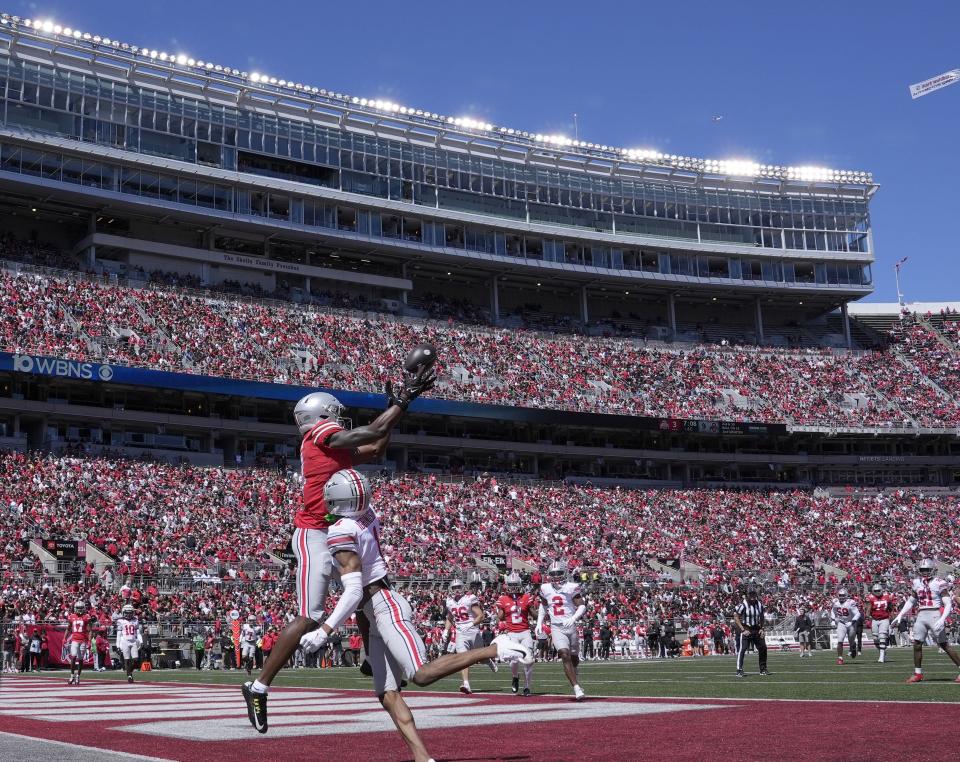 April 13, 2024; Columbus, Ohio, USA; 
Ohio State Buckeyes wide receiver Jeremiah Smith (4) playing for the scarlet team can't reel in a pass while defended by cornerback Davison Igbinosun (1) of the gray team of the during the first half of the LifeSports Spring Game at Ohio Stadium on Saturday.