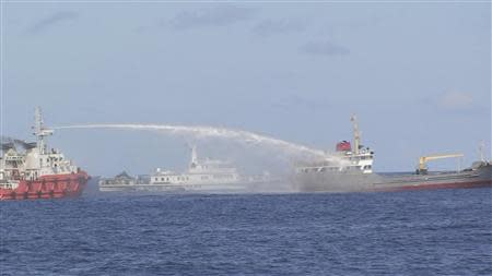 A Chinese ship (L) uses water cannon on a Vietnamese Sea Guard ship on the South China Sea near the Paracels islands, in this handout photo taken on May 3, 2014 and released by the Vietnamese Marine Guard on May 8, 2014. REUTERS/Vietnam Marine Guard/Handout via Reuters