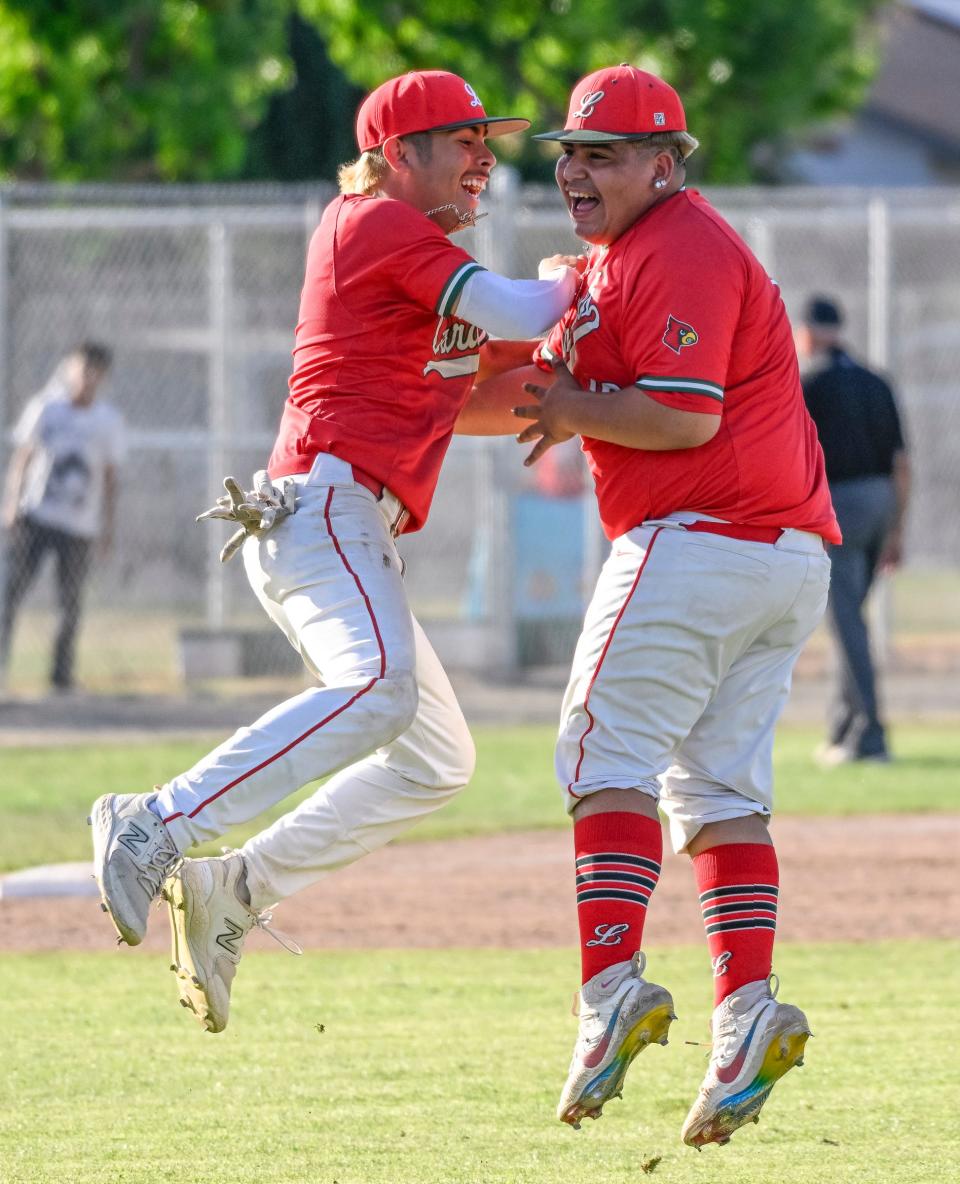 Lindsay's Nacho Espinoza, left, celebrates with pitcher John Mosqueda after their win over Woodlake in a Central Section Division VI high school baseball semifinal Tuesday, May 21, 2024