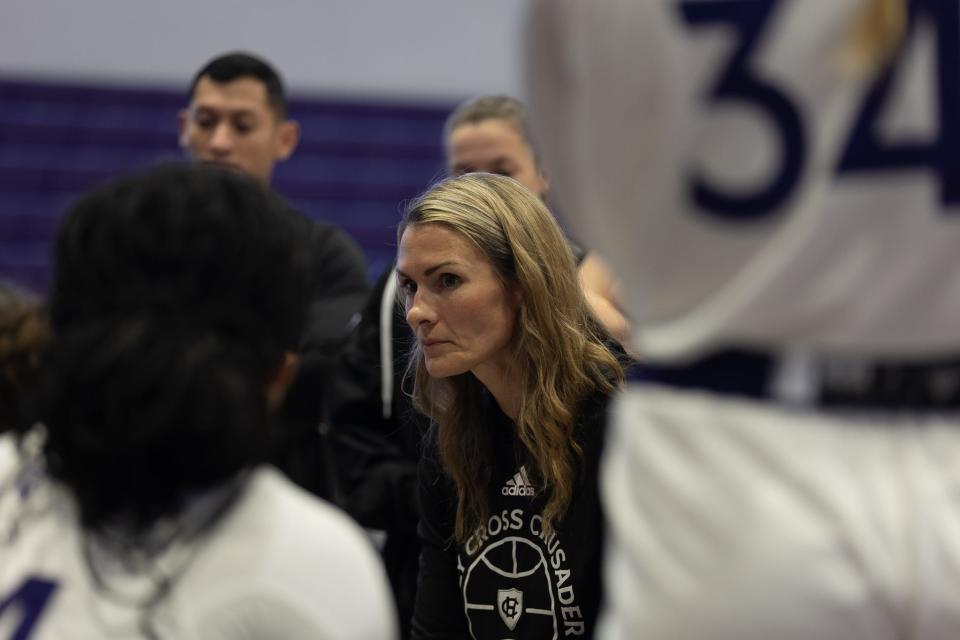 Holy Cross women's basketball coach Maureen Magarity addresses the Crusaders during a time out in the first quarter of Wedneday's game against New Hampshire.