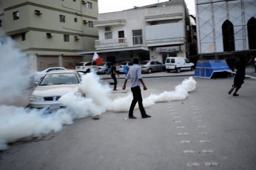 Bahraini Shiite Muslim protesters maneuver past tear gas as they clash with police during a protest in Bilad al-Qadeema, a suburb of the capital Manama. Bahrain's controversial Grand Prix race went off without incident on Sunday after a week of angry protests away from the F1 desert circuit that put the non-sporting focus on reform demands in the Gulf state