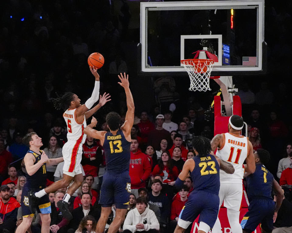 St. John's guard Daniss Jenkins (5) shoots over Marquette forward Oso Ighodaro (13) during the first half of an NCAA college basketball game in New York, Saturday, Jan. 20, 2024. (AP Photo/Peter K. Afriyie)