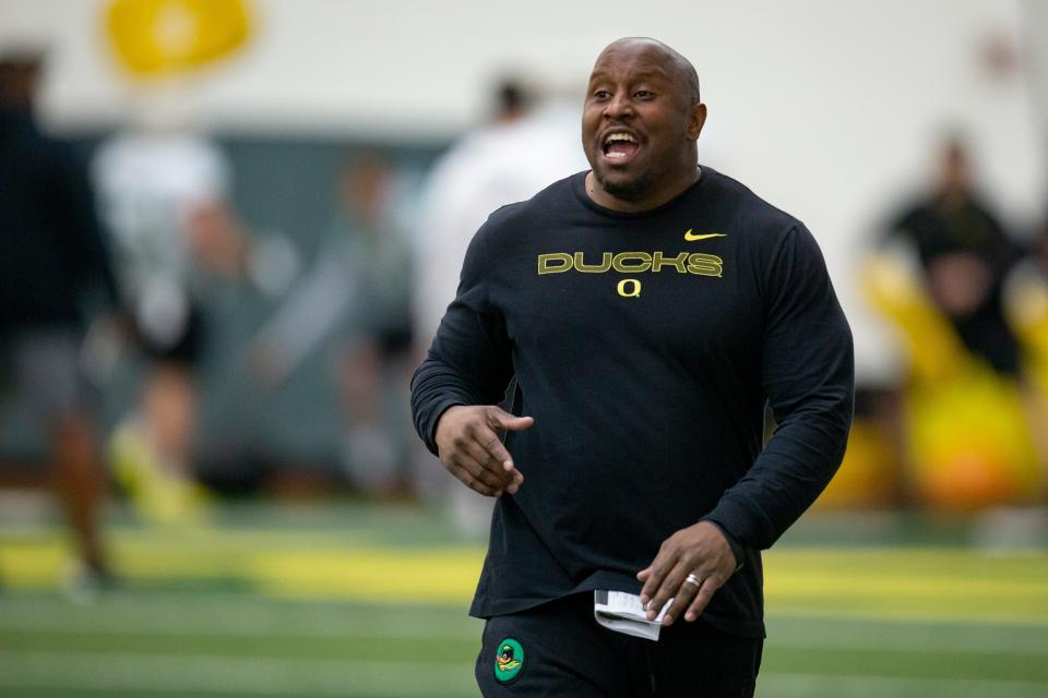 Oregon running backs coach Carlos Locklyn calls to players Thursday, April 14, 2022, during practice with the Ducks at the Moshofsky Center in Eugene. 