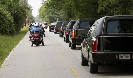 Hearses line up to leave the church following funeral services for members of the Stay family in Spring, Texas July 16, 2014. REUTERS/Daniel Kramer