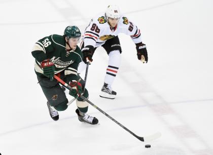 ST PAUL, MN - MAY 7: Erik Haula #56 of the Minnesota Wild controls the puck against Patrick Kane #88 of the Chicago Blackhawks during the third period in Game Four of the Western Conference Semifinals during the 2015 NHL Stanley Cup Playoffs on May 7, 2015 at Xcel Energy Center in St Paul, Minnesota. The Blackhawks defeated the Wild 4-3 to sweep the series. (Photo by Hannah Foslien/Getty Images)