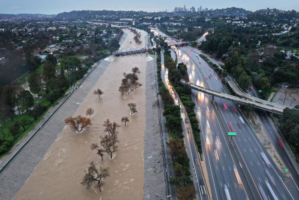 The Los Angeles River, which is often a small stream of moving water, is seen with increased water and rain runoff on Feb. 5.