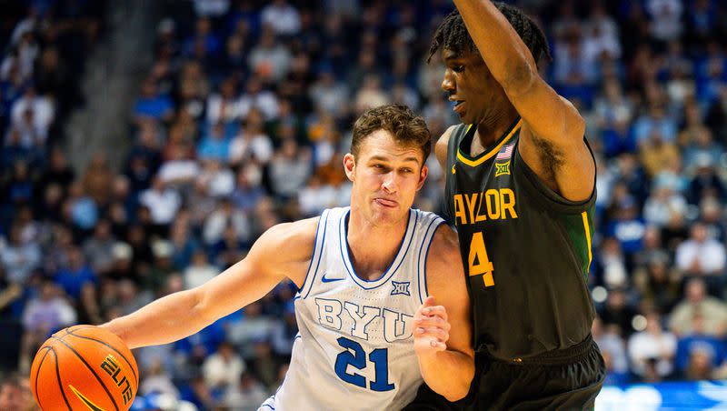 Brigham Young Cougars guard Trevin Knell (21) drives the ball to the basket with Baylor Bears guard Ja’Kobe Walter (4) on defense during a men’s college basketball game between Brigham Young University and Baylor University at the Marriott Center in Provo on Tuesday, Feb. 20, 2024.