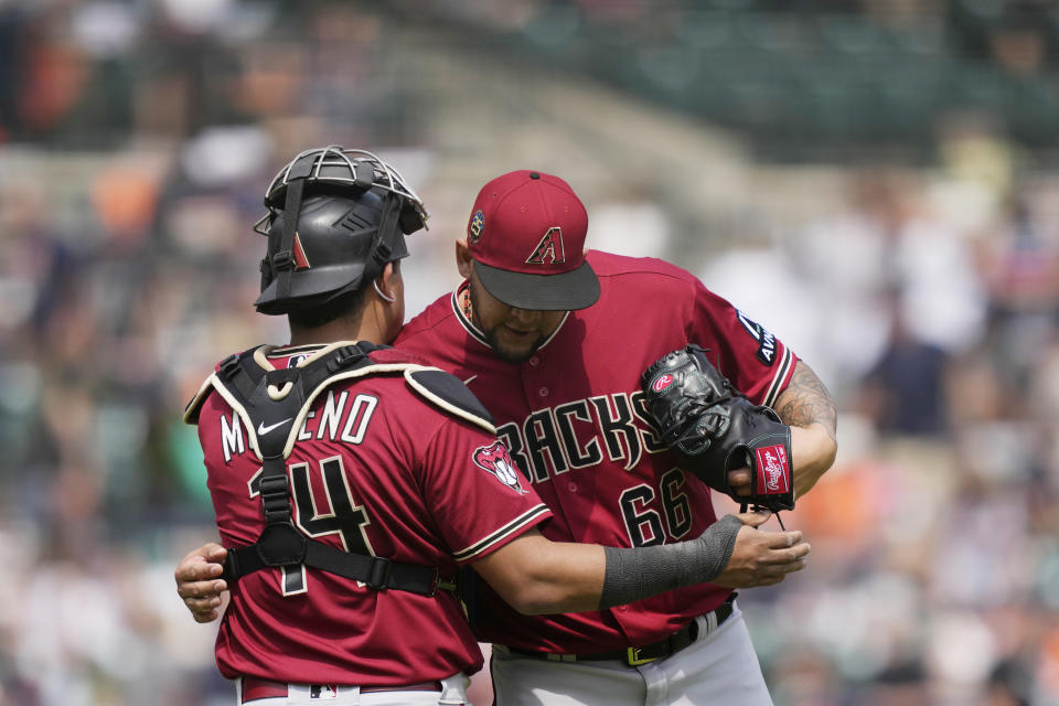 Arizona Diamondbacks relief pitcher Jose Ruiz (66) hugs catcher Gabriel Moreno (14) after the ninth inning of a baseball game against the Detroit Tigers, Saturday, June 10, 2023, in Detroit. (AP Photo/Carlos Osorio)