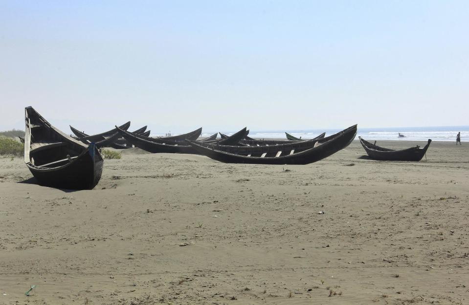 In this Jan. 16, 2017, photo, traditional wooden boats of the Rohingya fishermen sit along the beach abandoned in Maungdaw, western Rakhine state, Myanmar. Their usual, sturdy fishing boats were outlawed three months ago when Myanmar authorities launched a sweeping and violent counter-insurgency campaign in Rakhine state, home to the long-persecuted Rohingya Muslim minority. The ban on fishing boats _ meant to prevent insurgents from entering or leaving the country by sea _ is just one small provision in the wider crackdown, in which authorities have been accused of widespread abuses. (AP Photo/Esther Htusan)