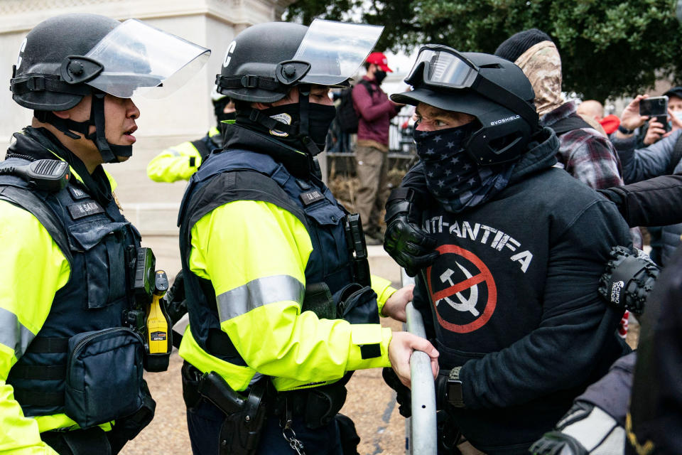 A protester, who claims to be a member of the Proud Boys, confronts police officers outside the Capitol (Alex Edelman / AFP via Getty Images file)