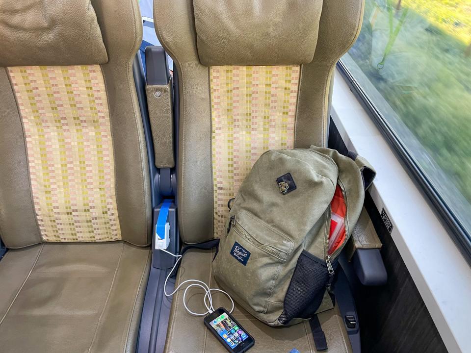 A backpack and phone charger on the Rocky Mountaineer.