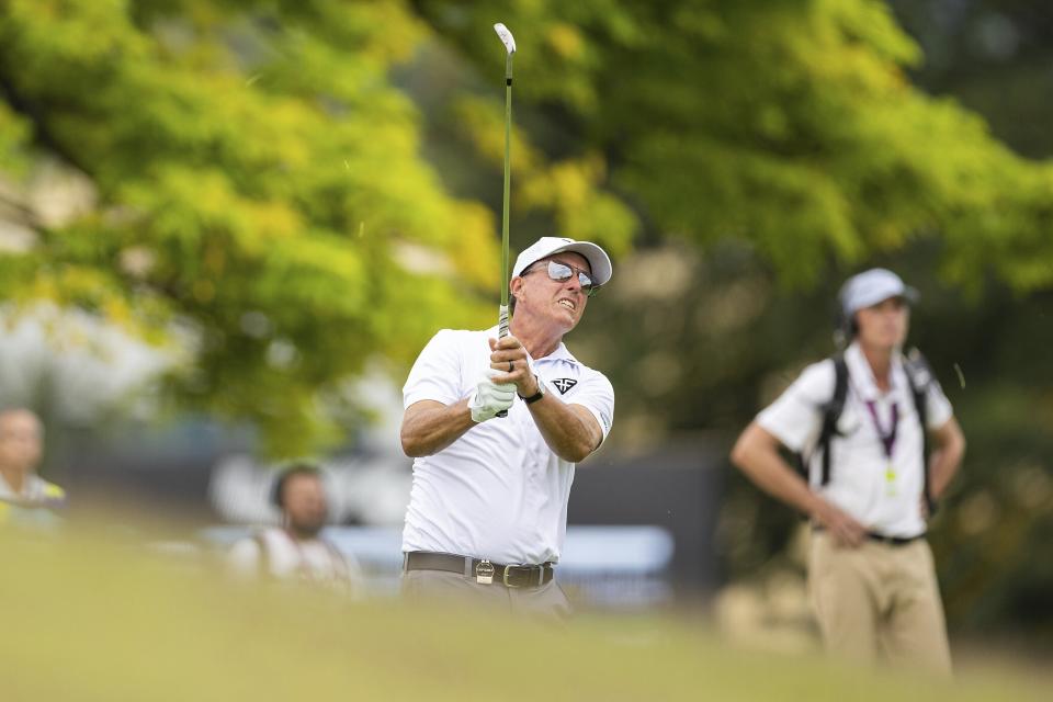 Captain Phil Mickelson of HyFlyers GC hits his shot from the fairway on the 16th hole during the first round of LIV Golf Singapore at the Sentosa Golf Club on Friday, April 28, 2023 in Sentosa, Singapore. (Doug DeFelice/LIV Golf via AP)