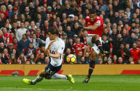 <p>Ben Davies attempts to block a shot from Manchester United’s Antonio Valencia</p>
