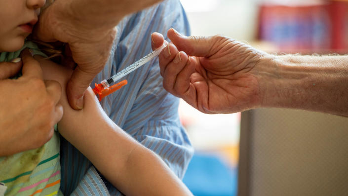 A young child receives a vaccination 