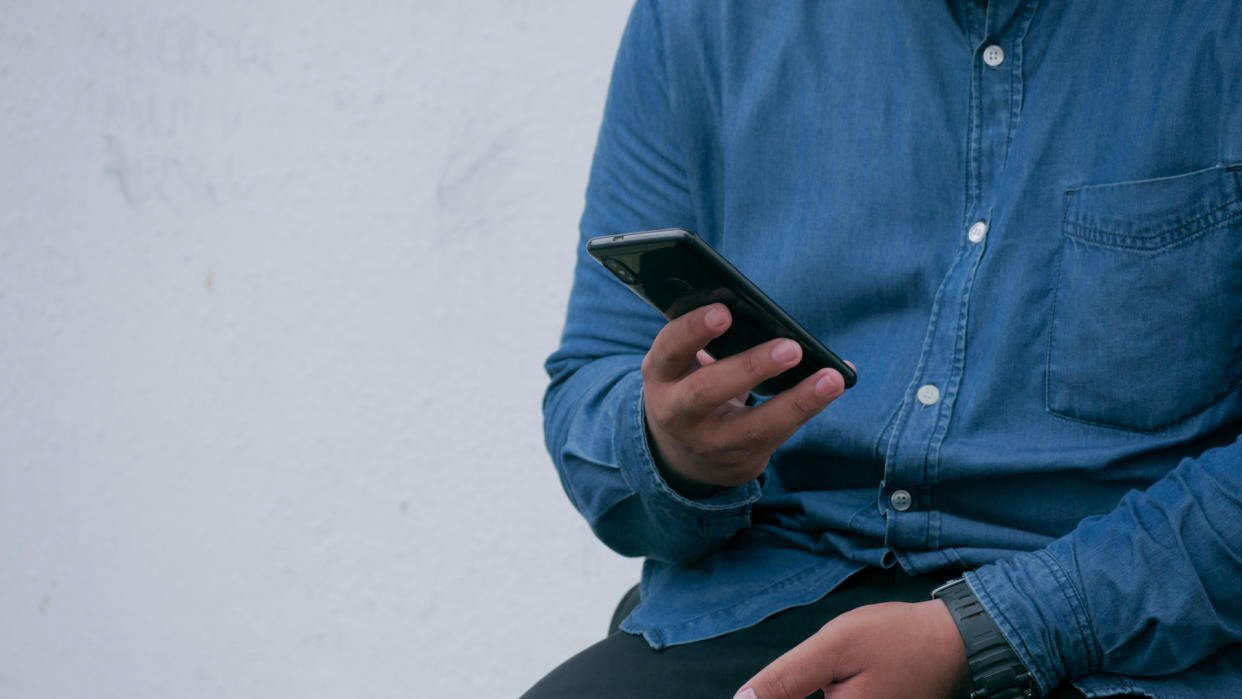  Man looking at phone contact. 