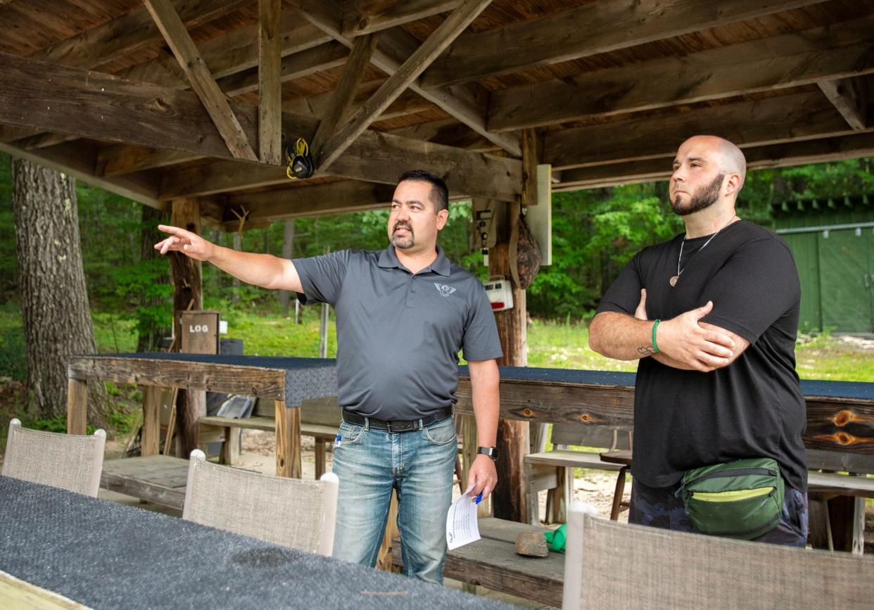 Westminster Rod & Gun Club President Matthew Pearson, left, explains the rules of the club’s shooting range Wednesday to new member Adam Smith.