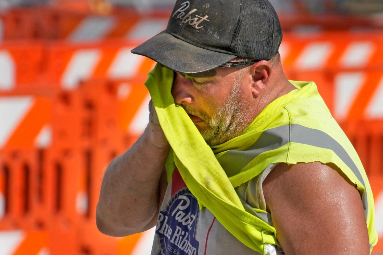 <span>A man wipes away sweat in Milwaukee, Wisconsin, on 17 June 2024.</span><span>Photograph: Mike De Sisti/The Milwaukee Journal Sentinel/Reuters</span>