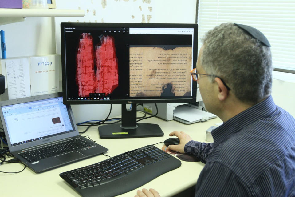 Jonathan Ben-Dov of the University of Haifa studies the Dead Sea Scroll. <cite>University of Haifa</cite>