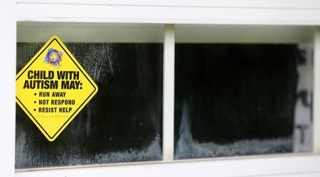 An Autism warning sign is shown in a window of the house of four year old Joshua Sekerak in Leetonia, Ohio, United States on May 21, 2016. REUTERS/Aaron Josefczyk