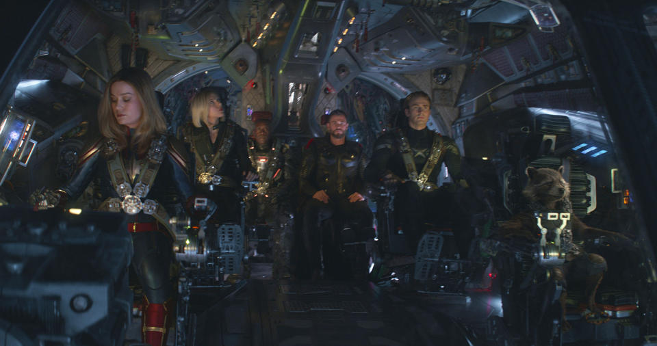 This image released by Disney shows, from left, Brie Larson, Scarlett Johansson, Don Cheadle, Chris Hemsworth, Chris Evans and the character Rocket, voiced by Bradley Cooper, in a scene from “Avengers: Endgame.” (Disney/Marvel Studios via AP)