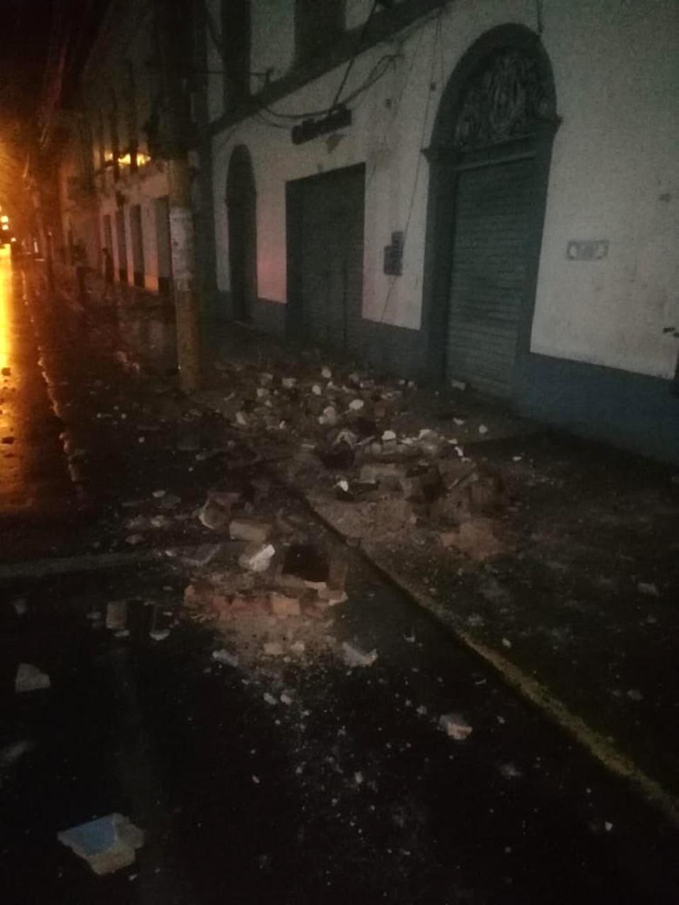 In this photo provided by Firefighters of Peru, debris covers a street after an earthquake in Yurimaguas Peru, Sunday, May 26, 2019. A powerful earthquake struck the Amazon jungle in north-central Peru early Sunday, the U.S. Geological survey reported, collapsing buildings and knocking out power to some areas. (Firefighters of Peru via AP)