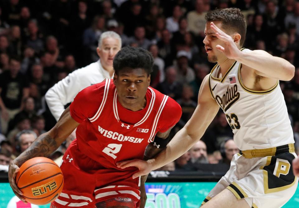 Wisconsin Badgers guard AJ Storr (2) drives into Purdue Boilermakers forward Camden Heide (23) during the NCAA menâ€™s basketball game, Sunday, March 10, 2024, at Mackey Arena in West Lafayette, Ind.