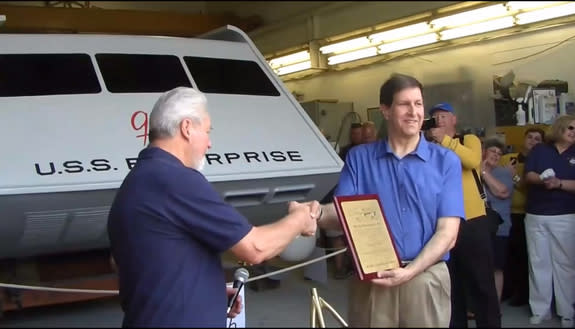 "Star Trek" superfan Adam Schneider (right) receives a plaque from Hans Mikatis of Master Shipwrights, Inc., during the unveiling of the restored Galileo shuttlecraft on June 22, 2013. The Galileo was originally featured on the original "Star T