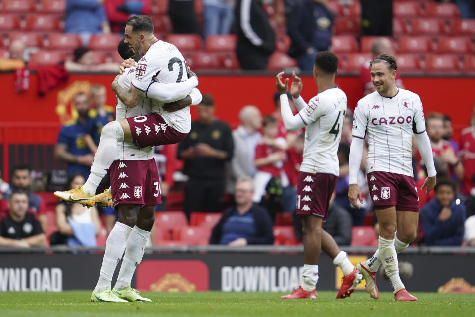 Aston Villa players celebrate at the end of the English Premier League soccer match between Manchester United and Aston Villa at the Old Trafford stadium in Manchester, England, Saturday, Sept 25, 2021. (AP Photo/Jon Super)