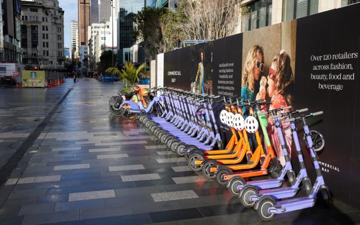A line of rental scooters and bicycles on a deserted street during a nationwide lockdown in Auckland, New Zealand on 18 August 2021 - Brendon O&#39;Hagan/Bloomberg