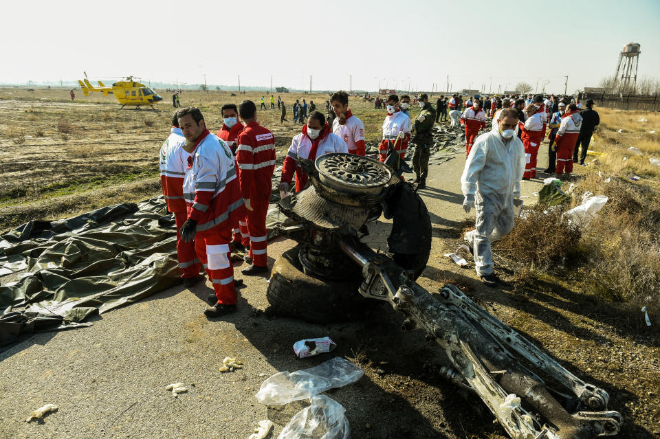 Rescue workers recover the bodies of victims of the wreckage of a Boeing Co. 737-800 aircraft, operated by Ukraine International Airlines, which crashed shortly after takeoff near Shahedshahr, Iran, on Wednesday, Jan. 8, 2020.  (Photo: Ali Mohammadi/Bloomberg via Getty Images)