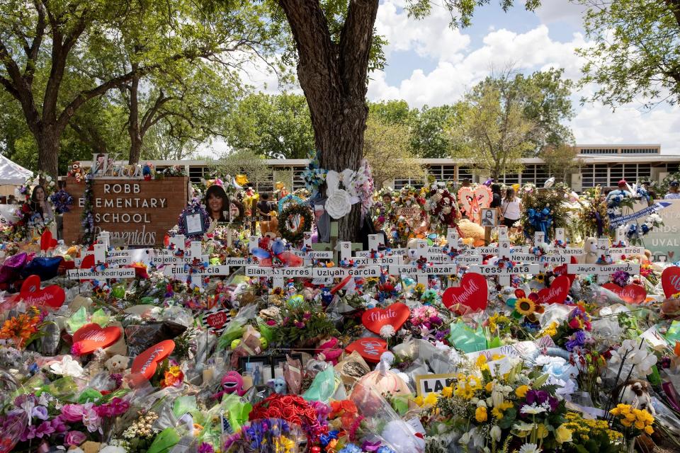 A campus memorial honors the 19 students and two teachers who died in a mass shooting on May 24 at Robb Elementary School in Uvalde, Texas.