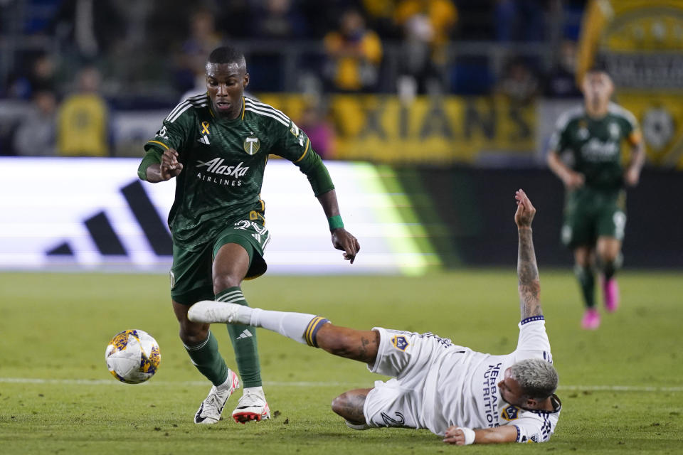 Portland Timbers defender Juan David Mosquera, left, dribbles past LA Galaxy midfielder Diego Fagundez during the second half of an MLS soccer match, Saturday, Sept. 30, 2023, in Carson, Calif. (AP Photo/Ryan Sun)
