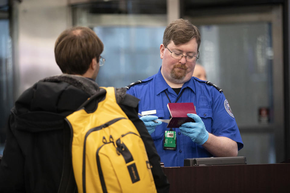 A Transportation Security Administration agent checks a flyer through security at O'Hare International Airport in 2019. (Erin Hooley/Chicago Tribune/Tribune News Service via Getty Images)