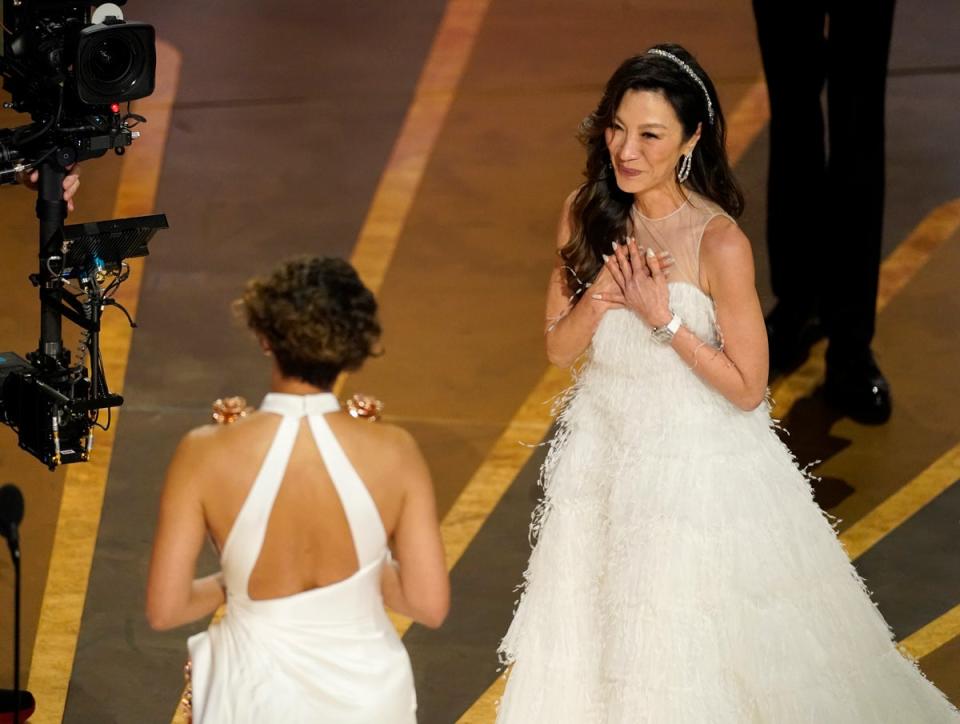 Halle Berry presents Michelle Yeoh with the award for best performance by an actress in a leading role for “Everything Everywhere All at Once” at the Oscars (Chris Pizzello/Invision/AP)