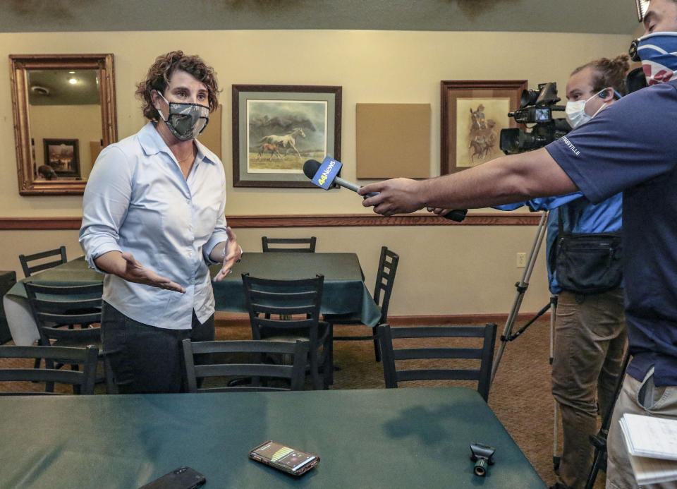 Democratic Kentucky Senate candidate Amy McGrath talks to the media during a stop at Moonlite Bar-B-Q Inn, Saturday, Aug. 1, 2020, in Owensboro, Ky, during a kickoff of her voter registration initiative, part of her statewide tour to register voters.(Greg Eans/The Messenger-Inquirer via AP)