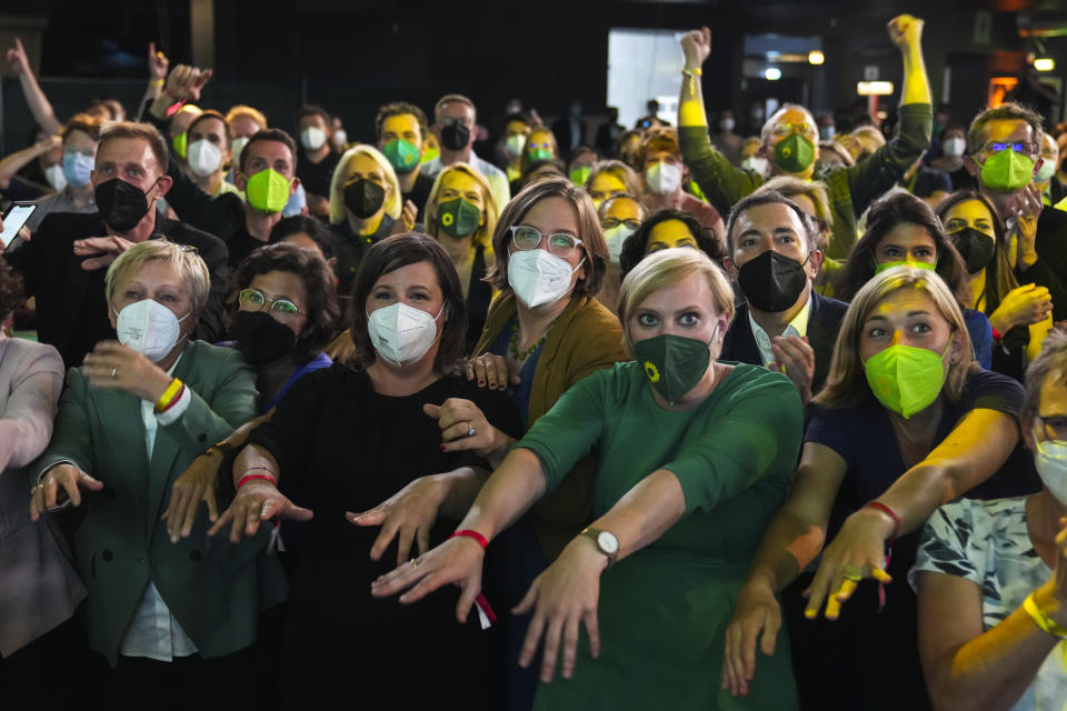 Members and supporters of the Green Party (Die Gruenen) gesture at the Green Party event after the close of polling stations during German parliament election, in Berlin, Germany, on Sunday, Sept. 26, 2021. (AP Photo/Matthias Schrader)