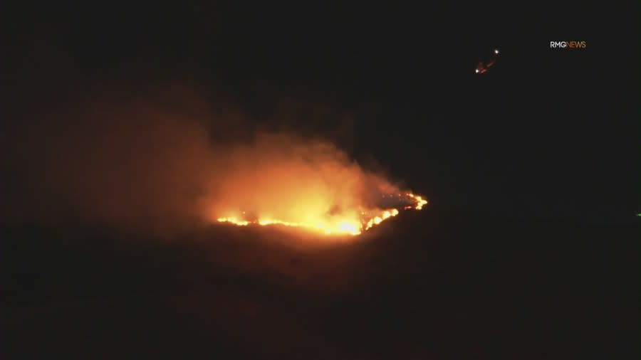 Fire crews work to contain overnight brush fire in San Fernando Valley amid Santa Ana winds