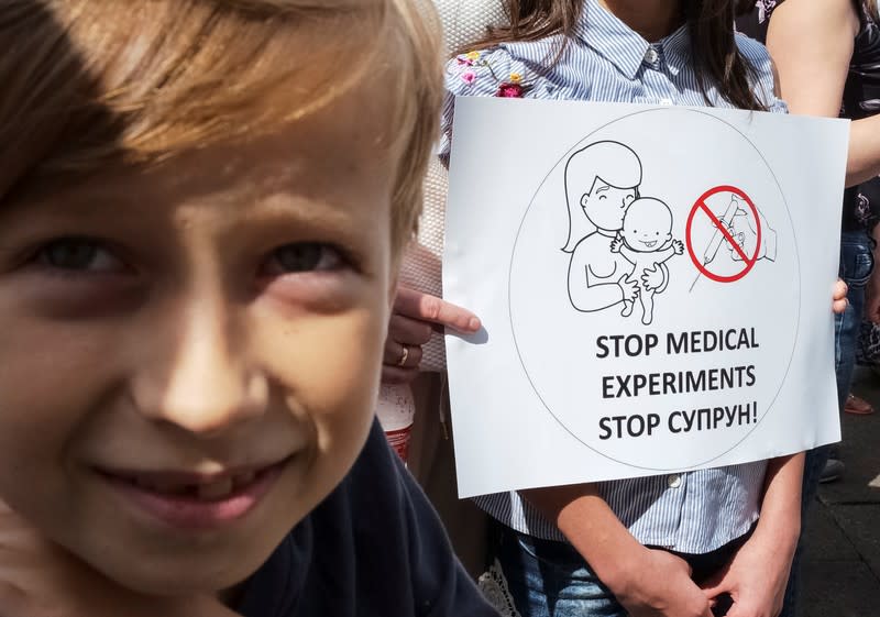 A boy attends a protest by anti-vaccination activists in Kiev