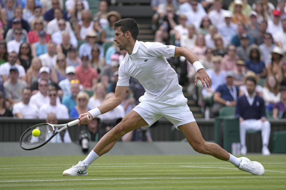 Serbia's Novak Djokovic returns the ball to Australia's Thanasi Kokkinakis during their singles tennis match on day three of the Wimbledon tennis championships in London, Wednesday, June 29, 2022. (AP Photo/Alastair Grant)