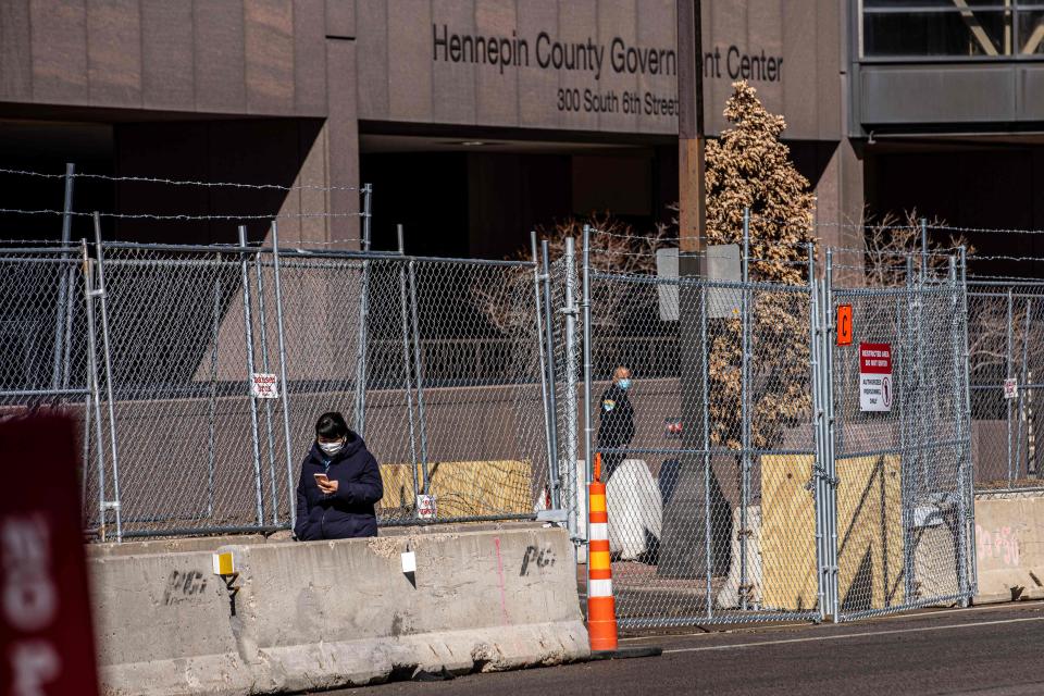 Layers of barbed wire fence cover the front of Hennepin County Government Headquarters in Minneapolis. Security measures were increased for the trial of former Minneapolis police officer Derek Chauvin in George Floyd's death.