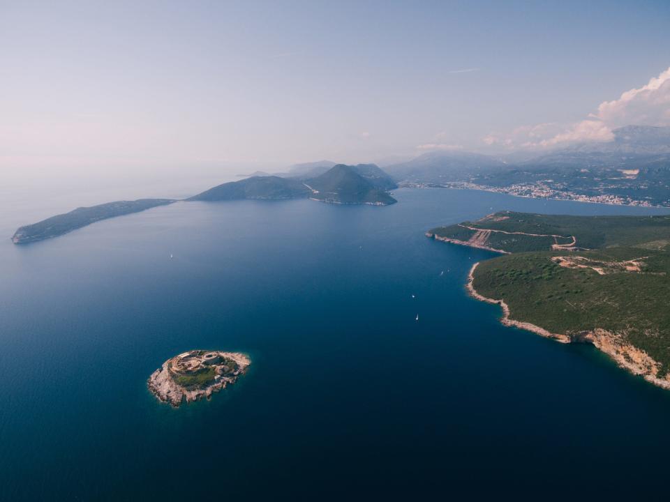 Fortress Mamula on the island against the backdrop of the mountains of Montenegro.