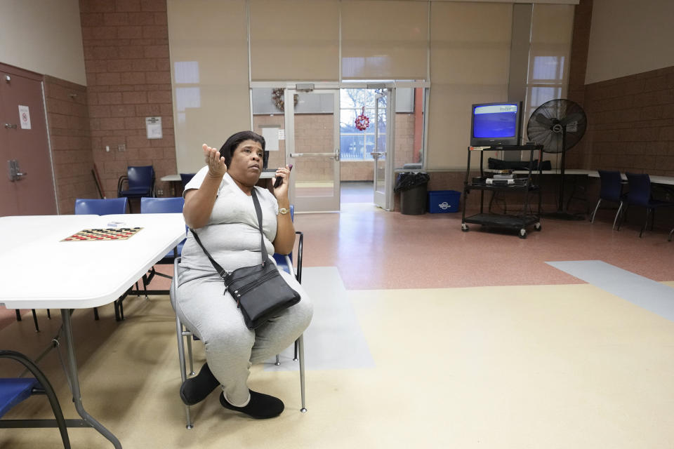 Debbie Fisher sits at the Farwell Recreation Center after her home lost power in Detroit, Friday, Feb. 24, 2023. Michigan is shivering through extended power outages caused by one of the worst ice storms in decades. (AP Photo/Paul Sancya)