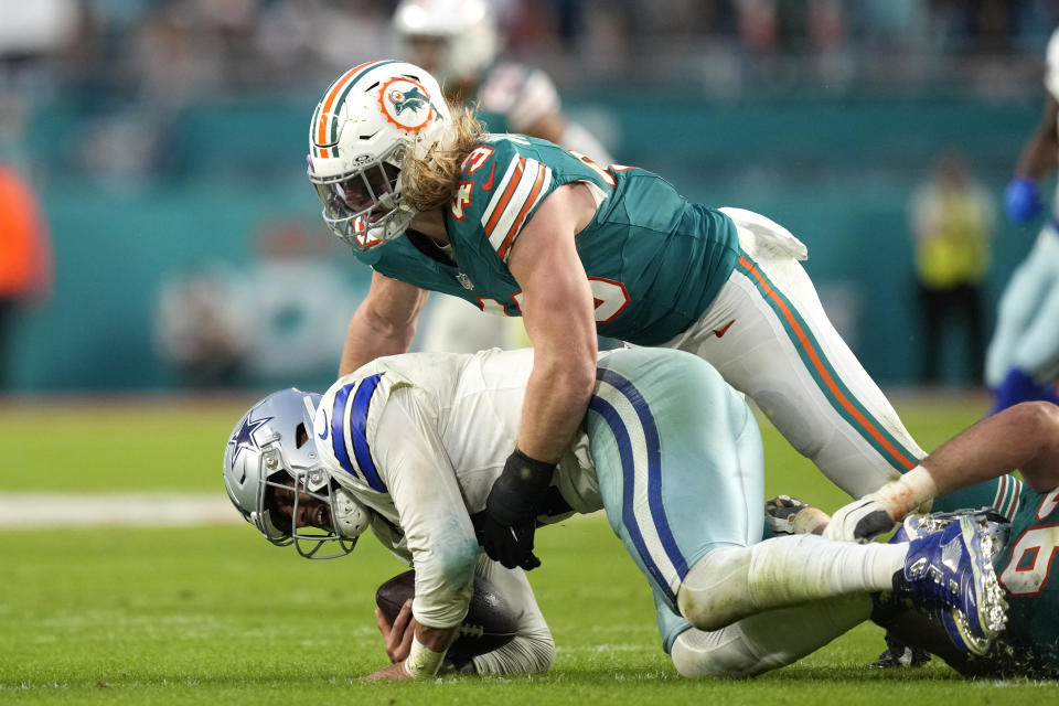 Miami Dolphins linebacker Andrew Van Ginkel (43) tackles Dallas Cowboys quarterback Dak Prescott during the first half of an NFL football game, Sunday, Dec. 24, 2023, in Miami Gardens, Fla. (AP Photo/Rebecca Blackwell)