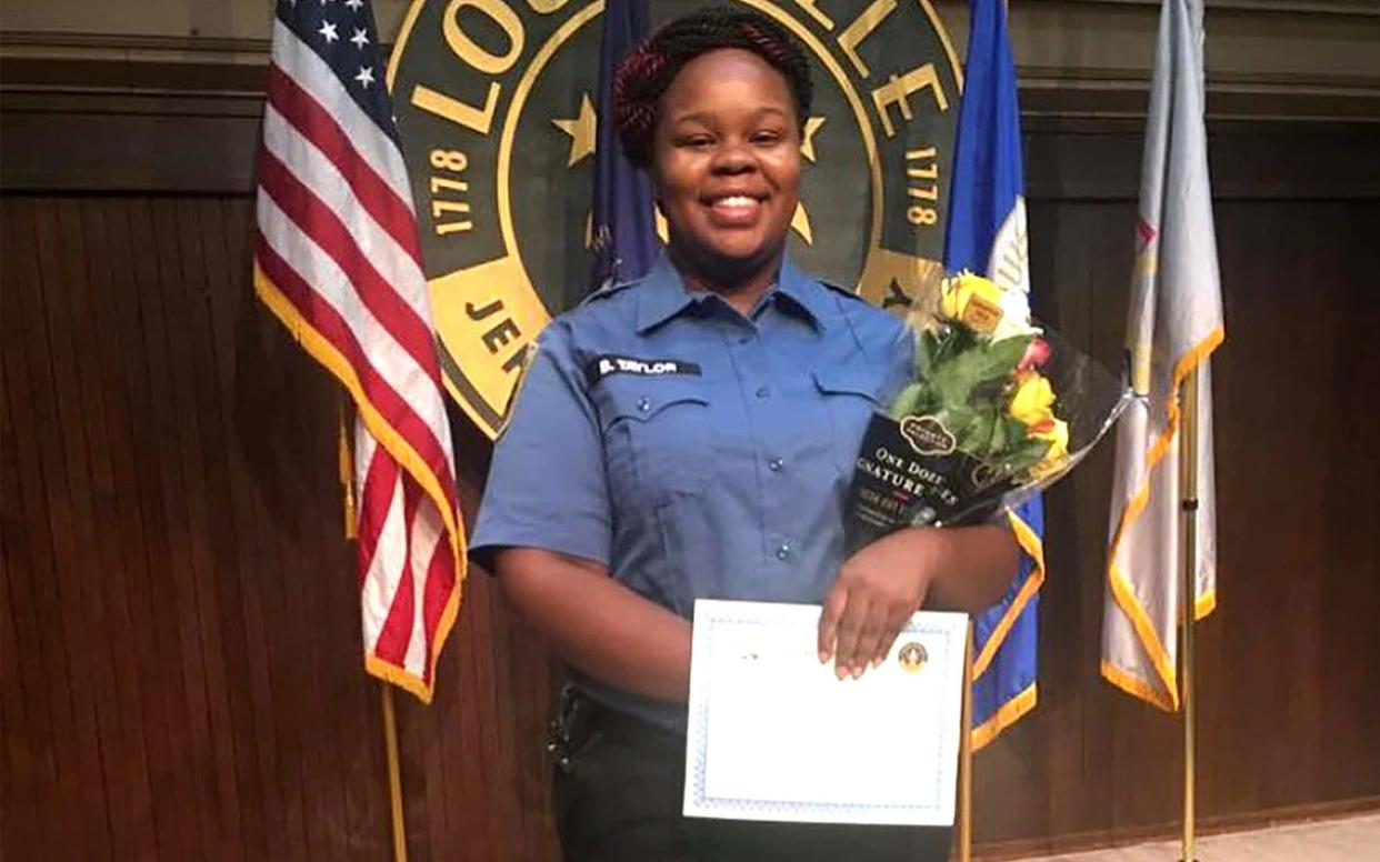 Breonna Taylor posing during a graduation ceremony in Louisville, Kentucky - AFP