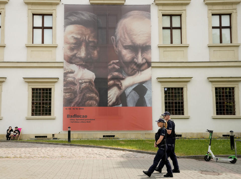 A poster of an exhibition by Chinese dissident artist Badiucao hangs outside the Center for Contemporary Art in Warsaw, Poland on Friday, June 16, 2023. The museum faced demands from the Chinese embassy not to open the exhibition, "Tell China's Story Well," which is highly critical of China's human rights record.(AP Photo/Czarek Sokolowski)