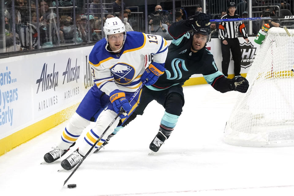 Buffalo Sabres' Mark Pysyk, left, skates past Seattle Kraken's Brandon Tanev during the first period of an NHL hockey game Thursday, Nov. 4, 2021, in Seattle. (AP Photo/Elaine Thompson)