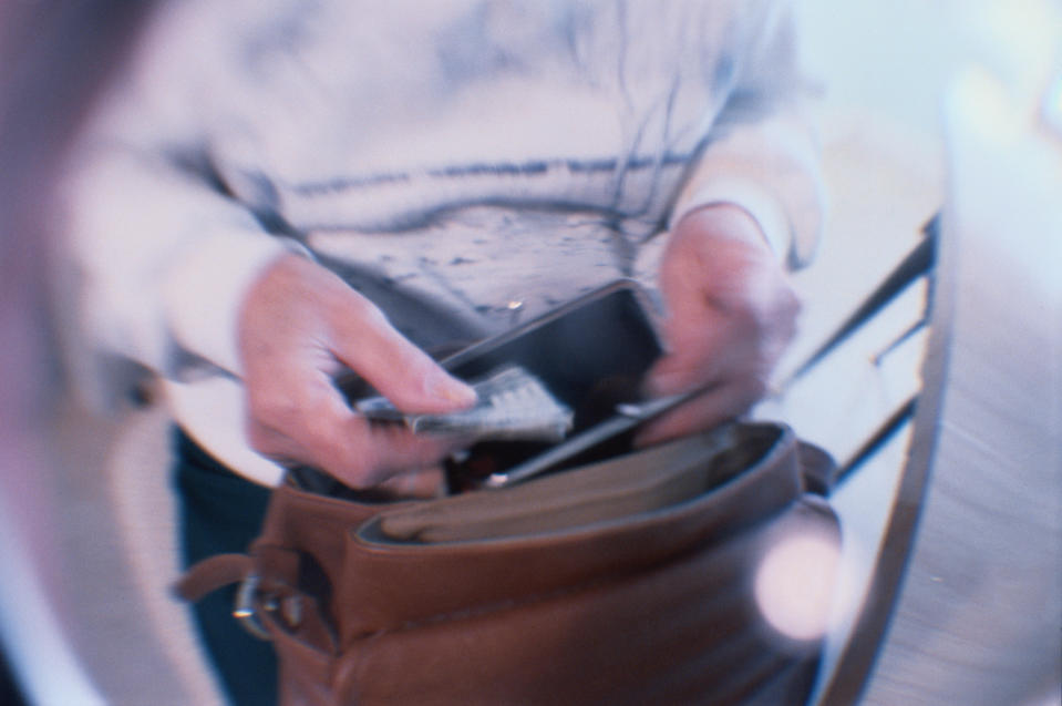 Close-up of someone opening a purse in a handbag