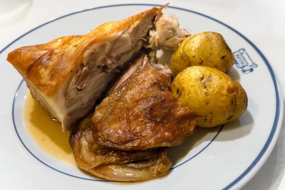 A plate of roast lamb and pork.