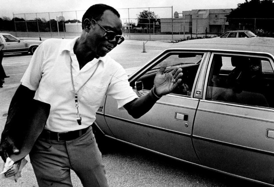 Driver ed teacher Elston Davis directs a student into a reverse turn in 1983.
